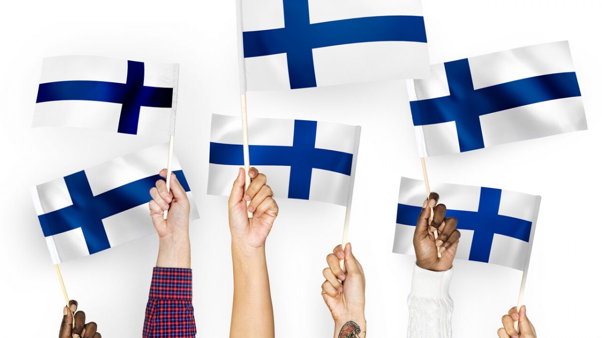 large hands waving flags finland