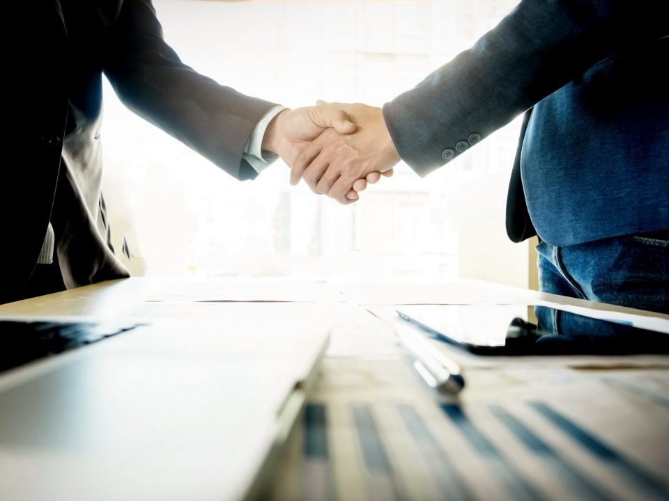 businessmen shaking hands during meeting scaled 1