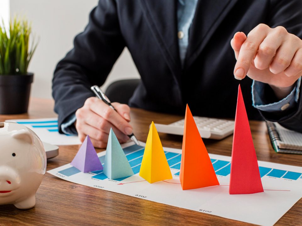 front view businessman with colorful cones representing growth